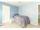 Blue bedroom featuring a bed, white nightstand and neutral carpet at 5849 Wooden Branch Dr, Indianapolis, IN 46221