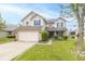 Inviting two-story home featuring blue shutters, a two-car garage, and a well-maintained front yard at 5849 Wooden Branch Dr, Indianapolis, IN 46221