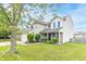 Traditional two-story home featuring tidy front yard landscaping, a two-car garage, and welcoming curb appeal at 5849 Wooden Branch Dr, Indianapolis, IN 46221