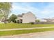 Exterior view of a well-kept home, with green lawn and fencing, nestled in a quiet residential street at 5849 Wooden Branch Dr, Indianapolis, IN 46221