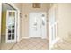 Spacious foyer with tile flooring, a front door with sidelights, and a staircase leading upstairs at 5849 Wooden Branch Dr, Indianapolis, IN 46221