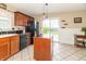 Kitchen featuring a center island and sliding glass door leading to the backyard at 5849 Wooden Branch Dr, Indianapolis, IN 46221