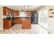 Well-appointed kitchen with dark cabinets, stainless steel appliances, and sliding glass doors to the backyard at 5849 Wooden Branch Dr, Indianapolis, IN 46221