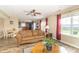 Inviting living room featuring a comfortable couch, hardwood flooring, and a view into the kitchen at 5849 Wooden Branch Dr, Indianapolis, IN 46221