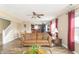 Open-concept living room with hardwood floors, a comfortable sofa, and an adjacent dining area at 5849 Wooden Branch Dr, Indianapolis, IN 46221