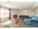Inviting living space with a fireplace, ceiling fan, wood flooring and a decorative area rug over wood floor at 5849 Wooden Branch Dr, Indianapolis, IN 46221