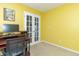 Bright home office with a computer desk, a comfortable chair, and double doors at 5849 Wooden Branch Dr, Indianapolis, IN 46221