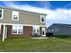Tan vinyl siding and brick accent the backyard and patio with grill and blue chairs at 6040 Bluecrest Dr, Brownsburg, IN 46234