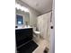 Bathroom features a dark vanity, toilet, and shower with modern fixtures and stylish decor at 6040 Bluecrest Dr, Brownsburg, IN 46234