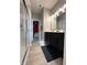 Bathroom featuring a tiled shower, dark vanity with dual sinks, and walk-in closet at 6040 Bluecrest Dr, Brownsburg, IN 46234