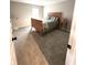 Comfortable bedroom with wooden bed frame, carpeted floors, and plenty of natural light at 6040 Bluecrest Dr, Brownsburg, IN 46234