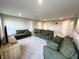 Spacious upstairs bonus room with neutral carpet and green sofas at 6040 Bluecrest Dr, Brownsburg, IN 46234