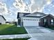Attractive single-Gathering home with a brick facade, white garage door, and a well-manicured lawn at 6040 Bluecrest Dr, Brownsburg, IN 46234
