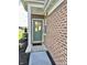 Close up of front door with brick exterior, storm door, and welcome mat at 6040 Bluecrest Dr, Brownsburg, IN 46234