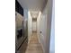 Hallway view showcases stainless steel fridge and white doors, enhancing the home's interior at 6040 Bluecrest Dr, Brownsburg, IN 46234