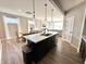Kitchen island with quartz countertops and a view of the adjacent dining and living area at 6040 Bluecrest Dr, Brownsburg, IN 46234