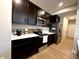 Dark kitchen features stainless steel appliances, light countertops, and dark cabinets at 6040 Bluecrest Dr, Brownsburg, IN 46234