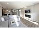 Open-concept living room with wood floors, fireplace and views into the dining and kitchen area at 6040 Bluecrest Dr, Brownsburg, IN 46234