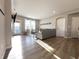 Bright living room with wood floors, neutral walls and large windows with bright light streaming in at 6040 Bluecrest Dr, Brownsburg, IN 46234