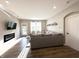 This cozy living room features an electric fireplace, a flatscreen tv and a comfortable gray sectional couch at 6040 Bluecrest Dr, Brownsburg, IN 46234