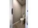 Cozy powder room with tiled floors and a modern toilet at 6040 Bluecrest Dr, Brownsburg, IN 46234