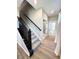 Carpeted staircase with a black railing leads to the upper level of the home at 6040 Bluecrest Dr, Brownsburg, IN 46234