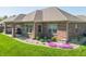 Brick home's landscaped backyard with patio at 6077 W David Wayne Dr, New Palestine, IN 46163