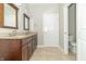 Bathroom featuring a double sink vanity with granite counters and tile flooring at 6077 W David Wayne Dr, New Palestine, IN 46163
