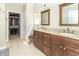 Bathroom with a double sink vanity, walk-in closet, and granite countertops at 6077 W David Wayne Dr, New Palestine, IN 46163