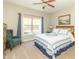 Inviting bedroom with a patterned quilt, large window, and blue curtains at 6077 W David Wayne Dr, New Palestine, IN 46163
