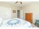 Comfortable bedroom with a ceiling fan, quilted bedding, and a large closet at 6077 W David Wayne Dr, New Palestine, IN 46163