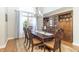 Formal dining room with hardwood floors, elegant chandelier, and large window at 6077 W David Wayne Dr, New Palestine, IN 46163