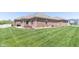 Beautifully landscaped backyard highlights the brick home, offering a serene outdoor living space at 6077 W David Wayne Dr, New Palestine, IN 46163