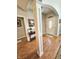 Inviting foyer featuring hardwood floors, decorative column, and an arched entryway with front door at 6077 W David Wayne Dr, New Palestine, IN 46163