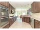 Well-lit kitchen with stainless appliances, double oven, and granite countertops at 6077 W David Wayne Dr, New Palestine, IN 46163