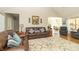 Open-concept living room featuring hardwood floors, comfortable seating, and seamless flow to other spaces at 6077 W David Wayne Dr, New Palestine, IN 46163