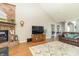 Bright living room featuring a fireplace, television, and plush seating at 6077 W David Wayne Dr, New Palestine, IN 46163