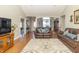 Spacious living room with hardwood floors, comfortable seating, and an open layout at 6077 W David Wayne Dr, New Palestine, IN 46163
