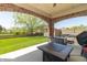 Covered patio with brick archway and outdoor furniture, offers a relaxing outdoor space overlooking a lawn at 6077 W David Wayne Dr, New Palestine, IN 46163