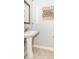 Bright powder room with pedestal sink and neutral decor at 6077 W David Wayne Dr, New Palestine, IN 46163