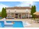 Backyard showcasing the inviting pool, bar, patio area, and outdoor entertainment space at 6096 E Conestoga Trl, Columbus, IN 47203