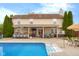 Backyard featuring a pool, outdoor bar, hot tub, and covered seating area at 6096 E Conestoga Trl, Columbus, IN 47203