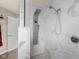 Modern bathroom featuring sleek marble walls, and a multi-functional shower system with rain head and body jets at 6096 E Conestoga Trl, Columbus, IN 47203