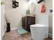 Charming bathroom featuring a sleek toilet, a dark wood vanity, and stylish decor, offering a cozy and functional space at 6096 E Conestoga Trl, Columbus, IN 47203