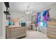 Cozy bedroom showcasing a chandelier, charming decor, and lots of natural light at 6096 E Conestoga Trl, Columbus, IN 47203