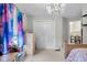 Bright bedroom with a large window, closet and chandelier at 6096 E Conestoga Trl, Columbus, IN 47203