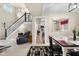 Cozy dining area and stairway with a view into the living room and fireplace at 6096 E Conestoga Trl, Columbus, IN 47203