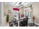 Bright dining area with table, bench seating, and elegant display cabinet at 6096 E Conestoga Trl, Columbus, IN 47203