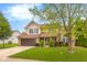 Inviting two-story home showcasing manicured lawn and lovely landscaping with a two car garage at 6096 E Conestoga Trl, Columbus, IN 47203