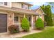 Cozy covered front porch with manicured landscaping and charming 'Welcome' sign at 6096 E Conestoga Trl, Columbus, IN 47203